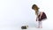 Cute child feeds fluffy Sheltie guinea pig at white background. Happy childhood concept. Slow motion