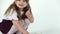 Cute child with fluffy Sheltie guinea pig at white background. Happy childhood concept. Close up