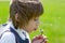 A cute child girl blowing a dandelion