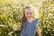 Cute child girl at camomile field daisy