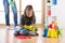 Cute child girl cleanses a floor in nursery at home