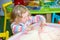 Cute child girl drawing draws developing sand in preschool at table in kindergarten