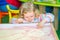 Cute child girl drawing draws developing sand in preschool at table in kindergarten