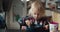 Cute child girl eats buckwheat porridge as a dinner on evening in dinning room