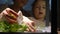 Cute child girl helps her mother to care for plants.