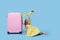 Cute child girl in summer dress with a pink suitcase and toys airplane is dreams of traveling to tropical countries after quaranti