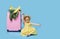 Cute child girl in summer dress with a pink suitcase and toys airplane is dreams of traveling to tropical countries after quaranti