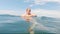 Cute child girl on swimming circle in sea. Family vacation concept.