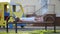 Cute child girl waiting for her mother laying on a bench on summer playground in kindergarten yard.