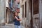 Cute child girl walking old city streets in Piran, Slovenia