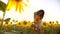 Cute child girl in yellow garden of sunflowers sunlight in summer. beautiful sunset little girl lifestyle in sunflowers