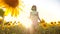 Cute child girl in yellow garden of sunflowers sunlight in summer. beautiful sunset little girl in sunflowers. lifestyle