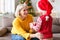 Cute child giving present for smiling elderly woman