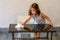 Cute child help mom cleaning glass table. Little girl make cleaning in room at home.