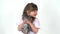 Cute child is holding grey chinchilla at white background. Happy childhood concept. Studio video kids emotion. Close up