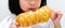 Cute child holds a delicious long bread in front of her face, preparing to eat it with gusto. Snacks that children like