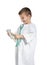 Cute child imagining himself as doctor while playing with stethoscope and toy on white