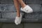 Cute child legs in slippers - cross legged