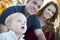 Cute Child Looks Up to Sky as Young Parents Smile