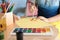 Cute child painting at table with his mother, closeup. Playing room