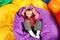 Cute child playing on colorful bean bag chairs