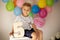 Cute child, preschool boy, celebrating birthday at home with homemade cake with raspberries, mint and candies