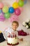 Cute child, preschool boy, celebrating birthday at home with homemade cake with raspberries, mint and candies