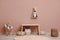 Cute child room interior with furniture, toys and wigwam shaped shelf on pink wall