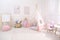 Cute child`s room interior with toys, modern furniture and play tent