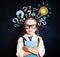 Cute child schoolgirl at the blackboard with lightbulb