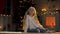 Cute child sitting on floor in room decorated for X-mas, waiting for miracle