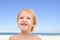 Cute child with sunscreen at the beach