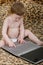 Cute child typing on a silver notebook