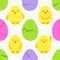 Cute childish hand drawn Easter seamless pattern with yellow little chickens emoji and eggs on polka dots background