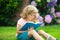 Cute childr boy with books outdoors. Summer camp. Kids learning and education concept.