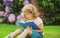 Cute childr boy with books outdoors. Summer camp. Kids learning and education concept.