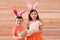 Cute children in bunny ears headbands holding basket with Easter eggs