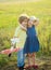 Cute children - daughter and son playing with toy airplane in the meadow in vintage color tone. Memories of childhood