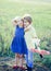 Cute children - daughter and son playing with toy airplane in the meadow in vintage color tone. Memories of childhood