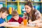 Cute children drawing with teacher at preschool class