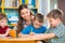 Cute children drawing with teacher at preschool class