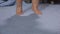 Cute children legs walk on toes on a blue blanket