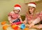 Cute children and mother bake cookies for Christmas. Family tradition