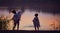 Cute children, siblings throwing stones in a lake at warm summer evening