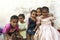 Cute children sitting on bench. Girl hugging the sisters in street of Old Town Zanzibar Tanzania