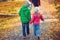 Cute children walking in autumn town