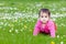 Cute chubby toddler crawling on the grass exploring nature outdoors in the park eye contact