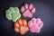 Cute colored paw shape soap on dark dark background. Dark background