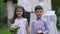Cute confident Middle Eastern flower girl and ring boy posing on marriage ceremony outdoors. Smiling happy children