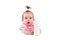 Cute confused baby girl in white shirt and pink bib holds bottle